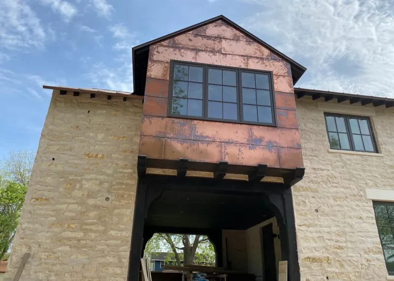 Copper metal panel facade on a stone building for Metal Roof Coating in Moss Bluff