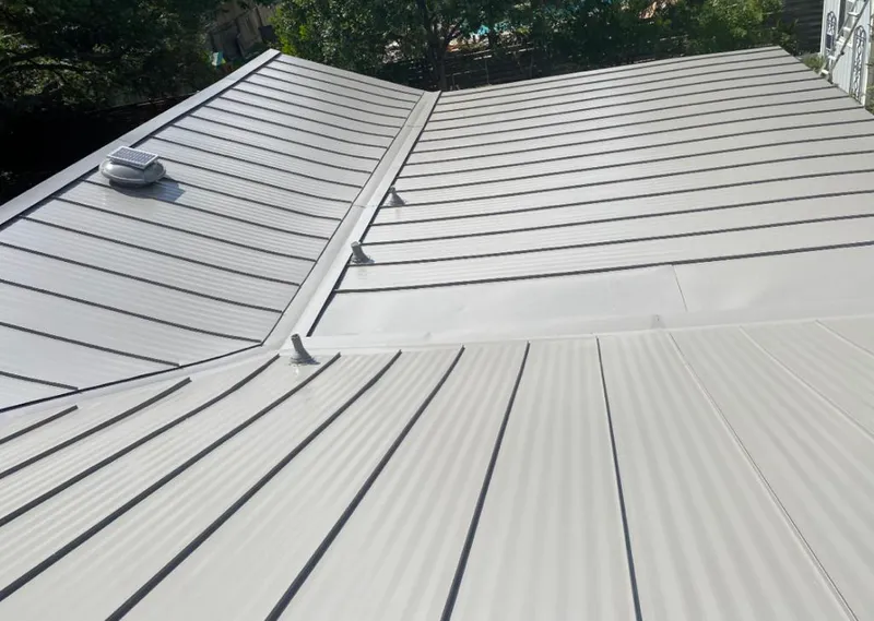 Solar attic fan installed on a metal roof for Roof Ventilation in Moss Bluff